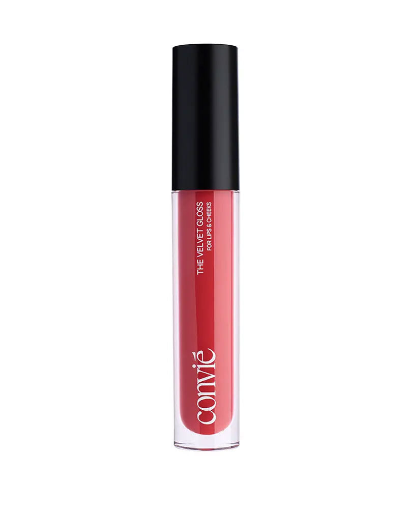 a pink lip gloss in a clear bottle with black cap standing upright