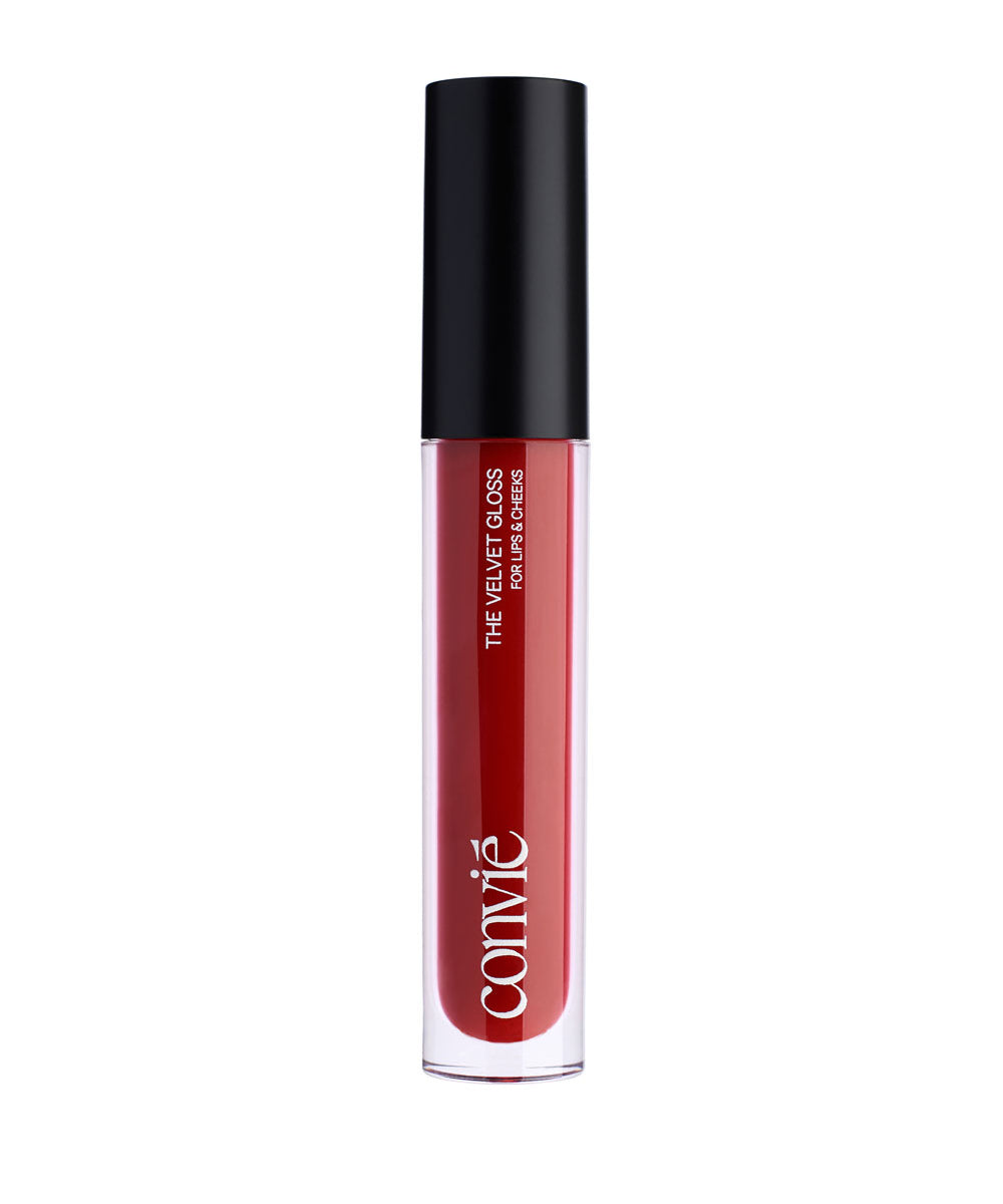 a red lip gloss in a clear bottle with black cap standing upright